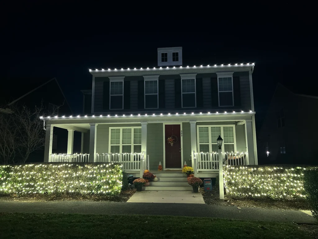 Colonial home with warm white C9 Christmas roofline lighting