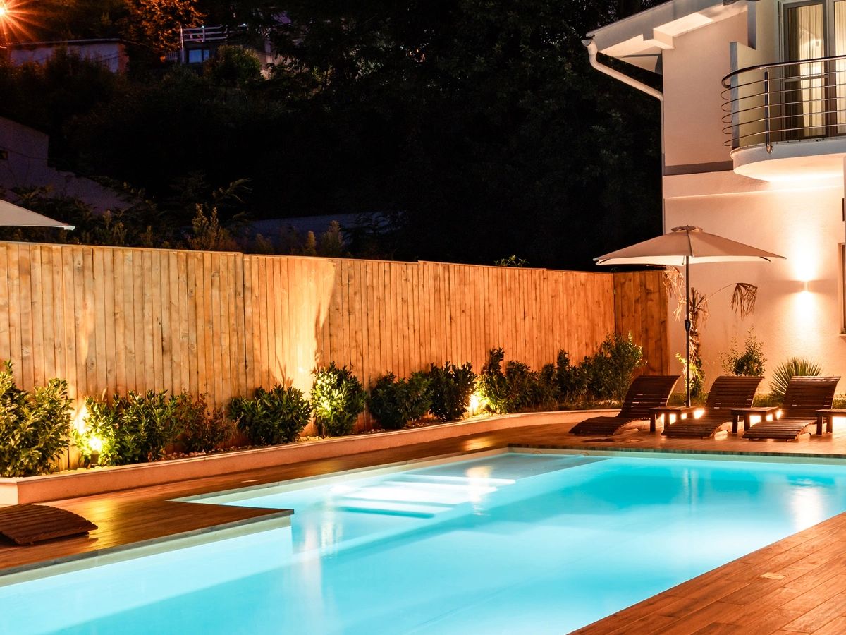 Evening patio and pool lit for entertaining